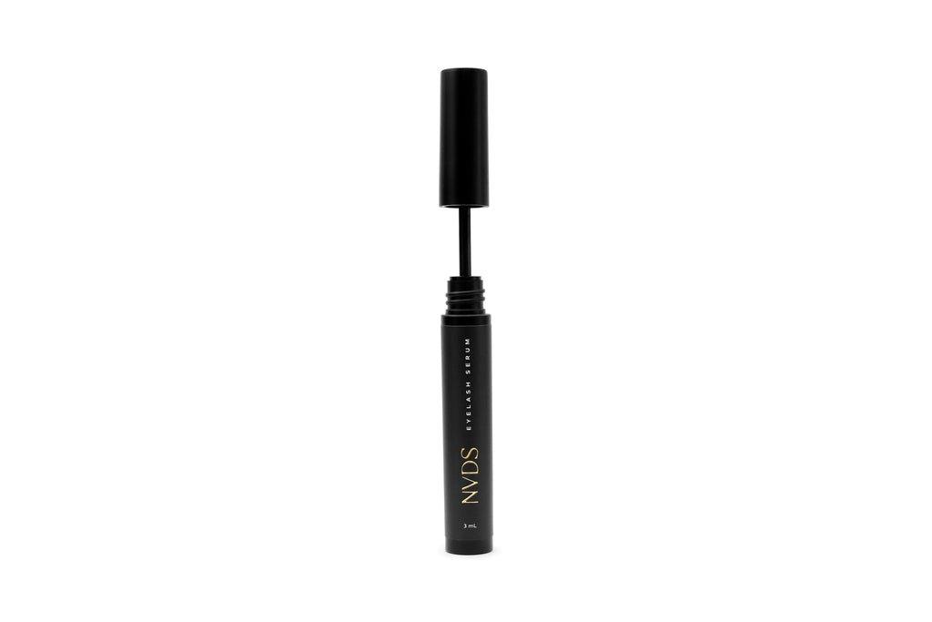 Bottle of NVDS Lash Growth Serum with a sleek design and a black cap.